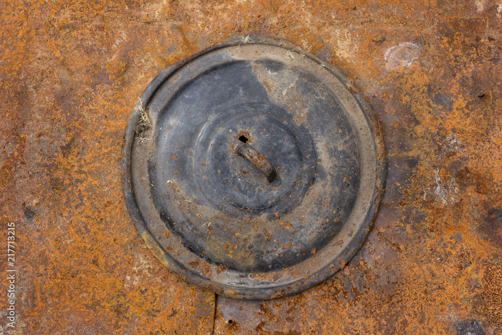 Old rusted pot lid on a rusted metal plate background Old rusted pot lid on a rusted metal plate background