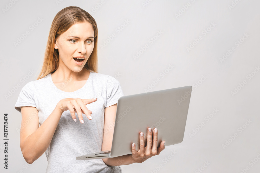 Portrait of happy wow young beautiful surprised woman standing with laptop isolated on white background. Space for text. Portrait of happy wow young beautiful surprised woman standing with laptop isolated on white background. Space for text.