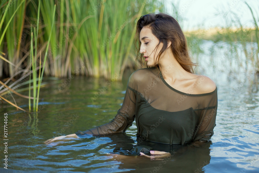 Fototapeta premium summer portrait of a swimming girl, emotional portrait of a girl in the water