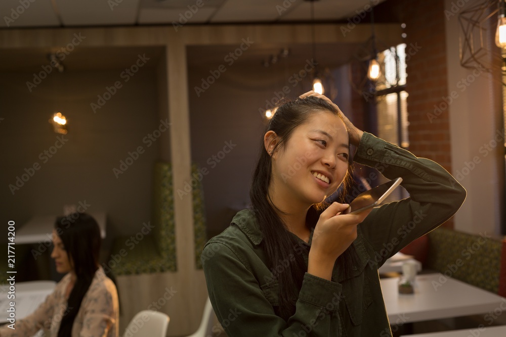 Female executive talking on mobile phone Female executive talking on mobile phone