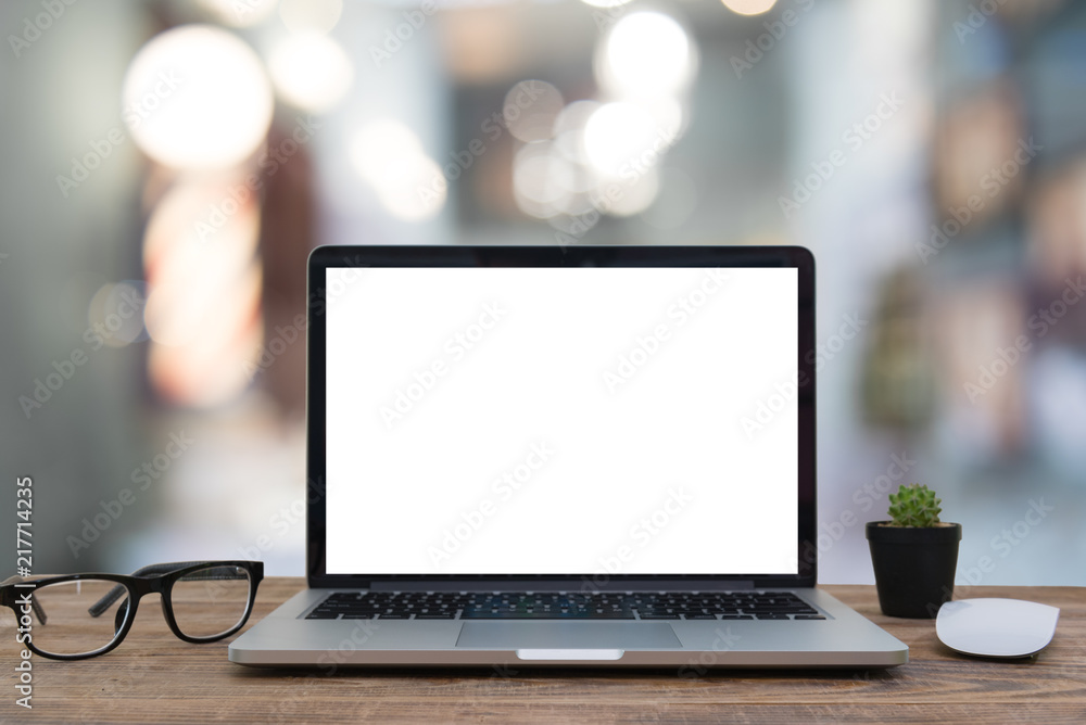 Computer notebook and mouse with a coffee shop behind the scenes Blur Computer notebook and mouse with a coffee shop behind the scenes Blur