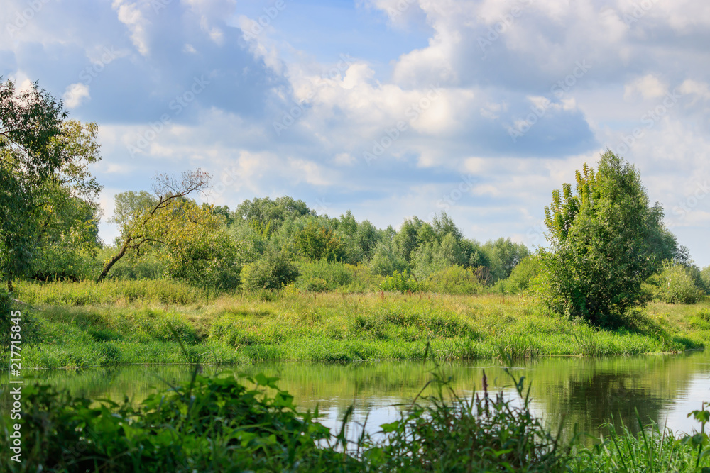 River landscape on a background of blue sky with clouds at sunny summer day River landscape on a background of blue sky with clouds at sunny summer day
