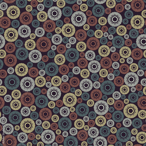 Vintage geometric seamless pattern. Elements of round shape  located on a dark background.