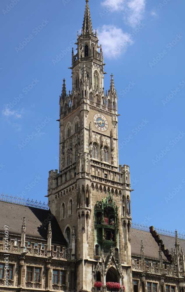 Obraz premium Munich Germany - the clock tower of the new City Hall in Marienplatz richly decorated in Gothic Revival architecture and the Glockenspiel with the medieval life-size figures