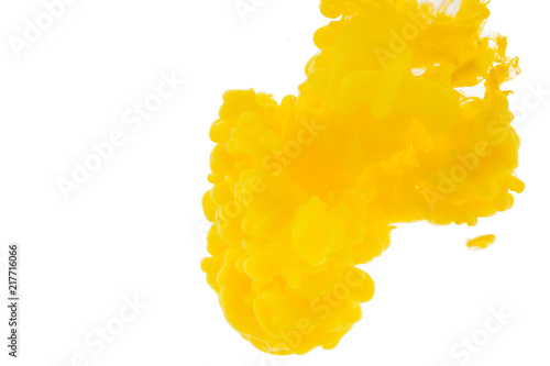 Abstract paint background. Yellow acrylic paint in water.