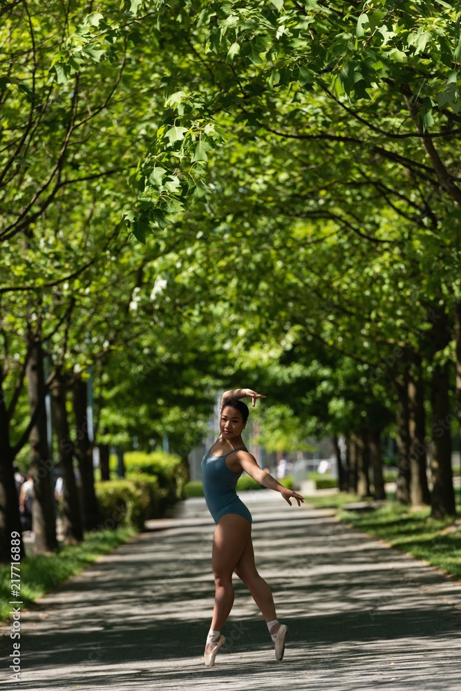 Female ballet dancer dancing on the road Female ballet dancer dancing on the road