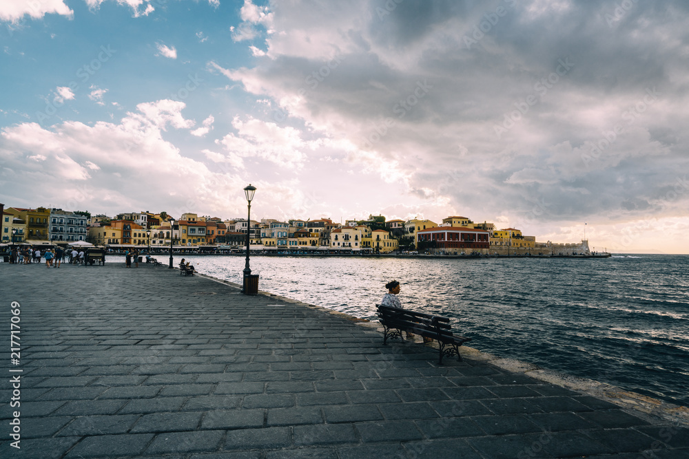 Panorama venetian harbour waterfront and Lighthouse in old harbour of Chania at sunset, Crete, Greece