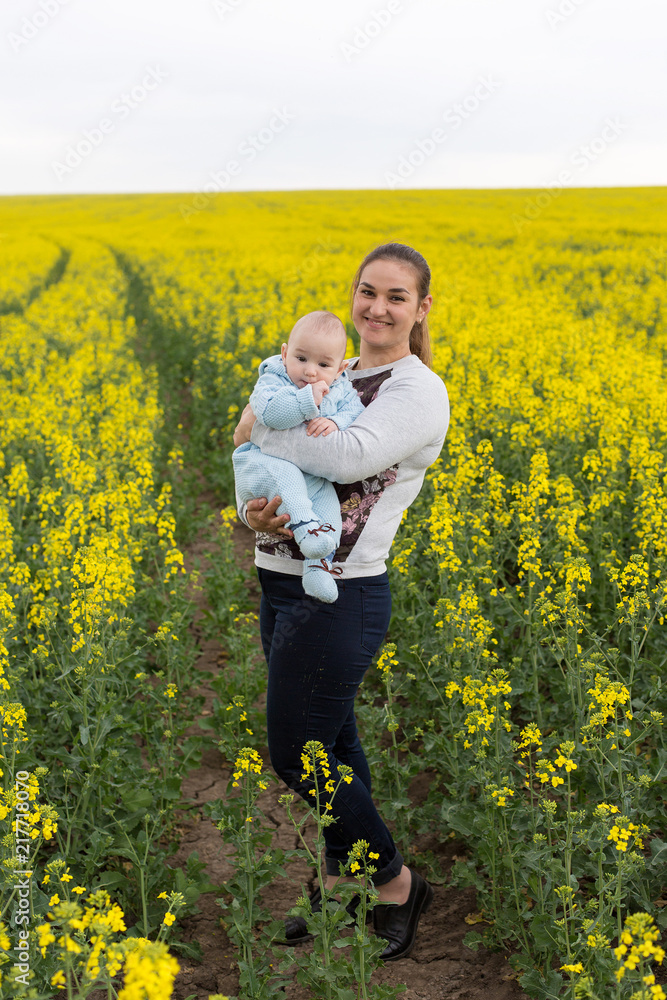 Happy mother with the child in the field Happy mother with the child in the field