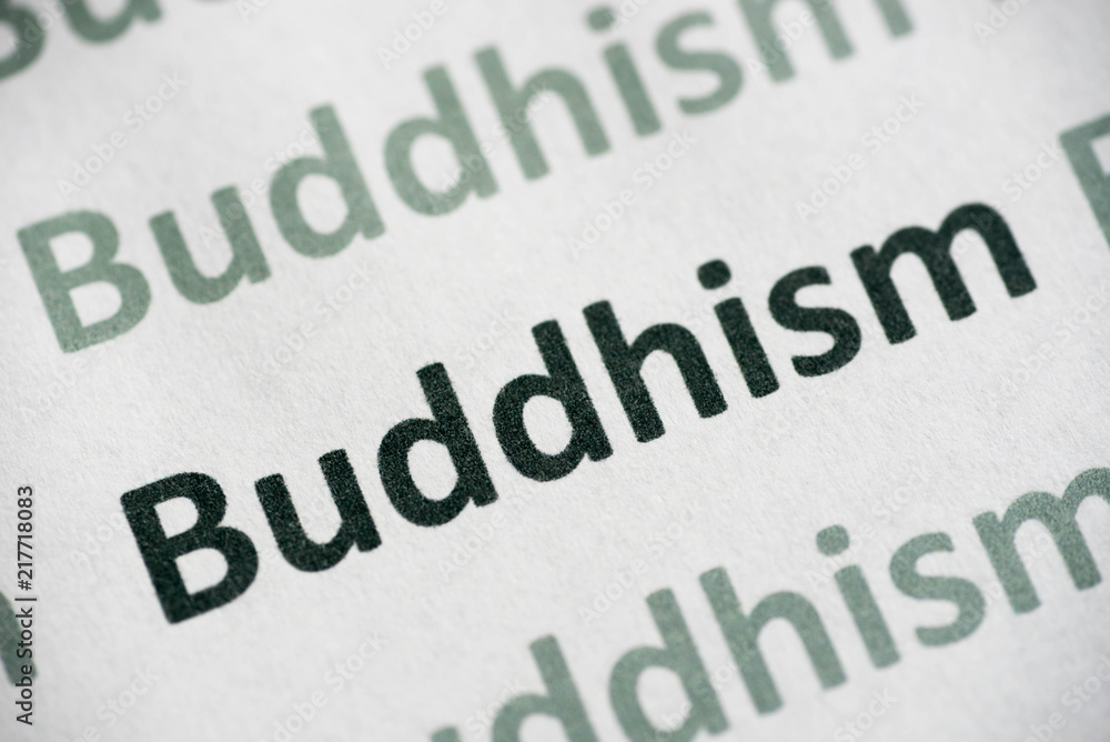 word Buddhism printed on paper macro