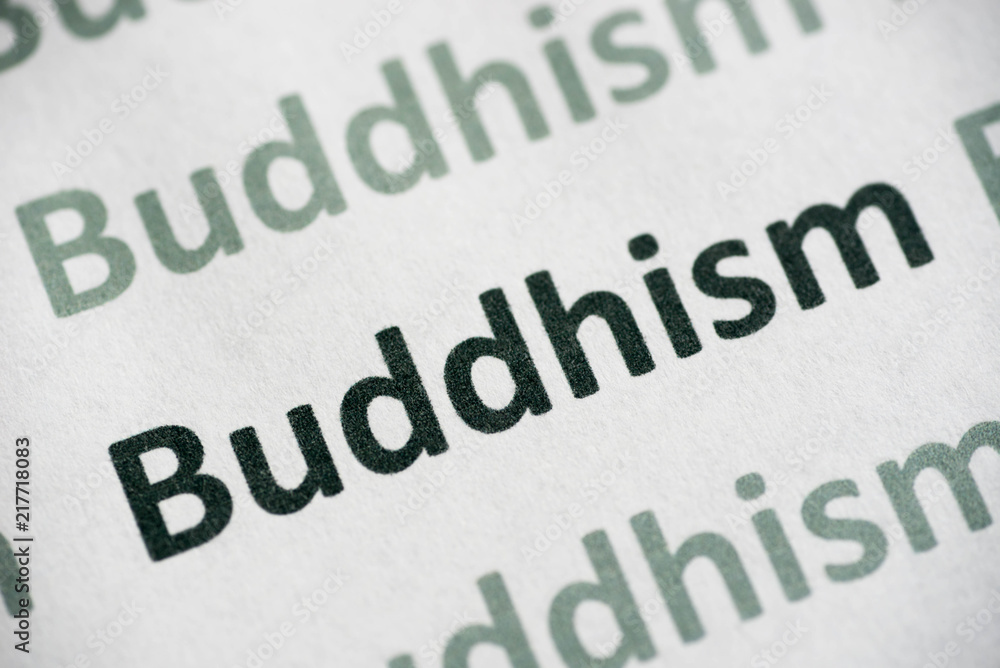 word Buddhism printed on paper macro word Buddhism printed on paper macro