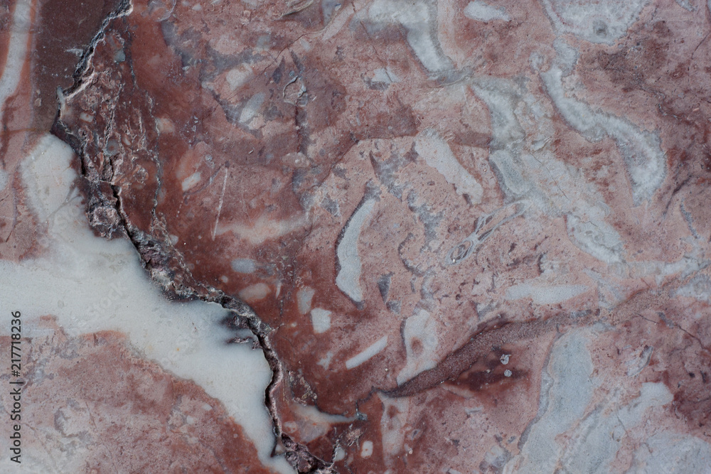 Fototapeta premium Reddish brown structure with fractures and gray spots. Natural material. Classic travertine texture.