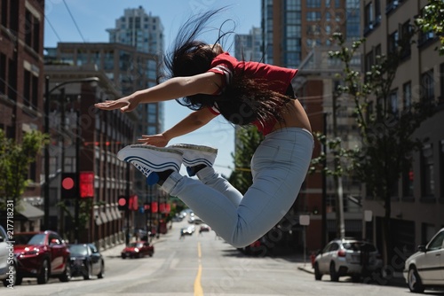 Female street dancer dancing in the street photo