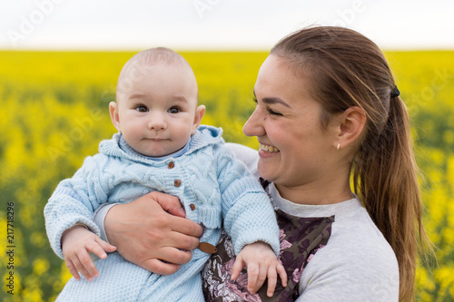 Happy mother with the child in the field 