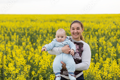 Happy mother with the child in the field 