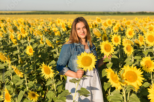Pregnant girl in sunflowers, happy girl waiting for the baby