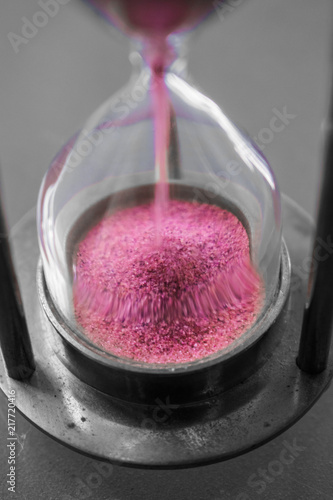 Pink sand falling in hourglass - selective colored