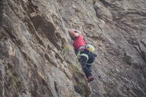 Woman Climbing a Mountain