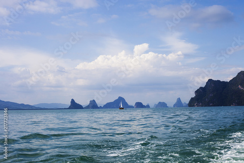 Floating yacht in Andaman sea and islands silhouettes, Thailand