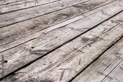 White boardwalk of stripped weathered washed out wooden planks with scratches. Abstract natural texture background