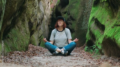 Girl hippest meditates in beautiful mountains, travel and relaxation photo