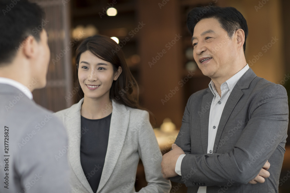 Cheerful business people talking indoors Cheerful business people talking indoors