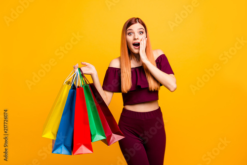 Black friday! Wondered young woman with surprised face holds his