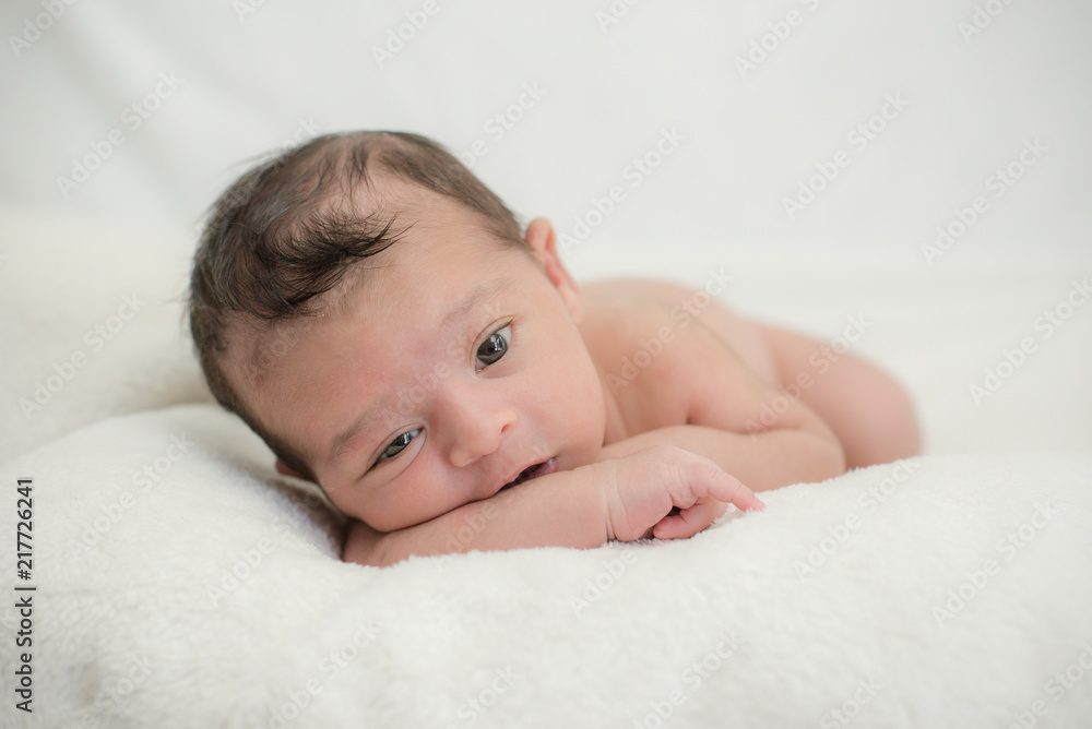 Cute newborn baby on a blanket - happy family moments concept Cute newborn baby on a blanket - happy family moments concept