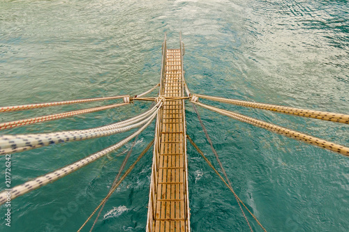 The gangway and trail on the water from the ship leaving for the sea