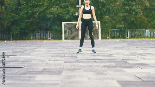 Young Athlete Woman in Sport Outfit Engaged in Fitness on the Sports Field in the Park. photo