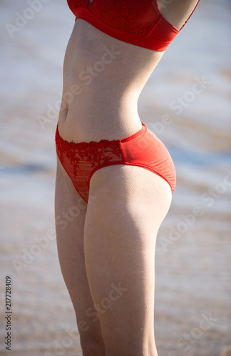 Beautifulyoung woman in red transparent swimsuit photo