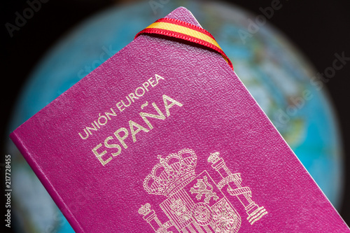 Spanish passport and earth globe, travel around the world concept