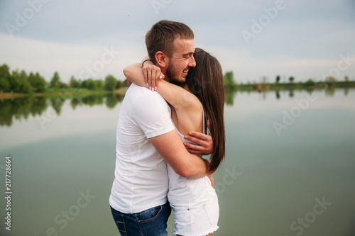 Couple in love hug each other near the lake © Aleksandr