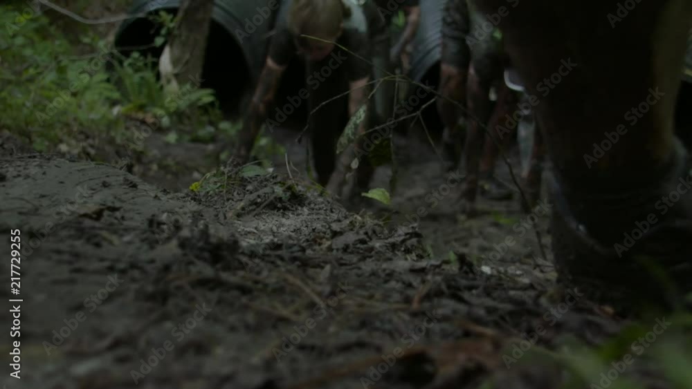 people running a mud race high speed and slow motion people running a mud race high speed and slow motion
