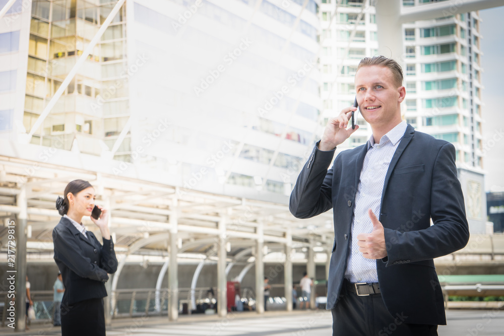 business man show thumb up and using mobile phone to talk about business business man show thumb up and using mobile phone to talk about business