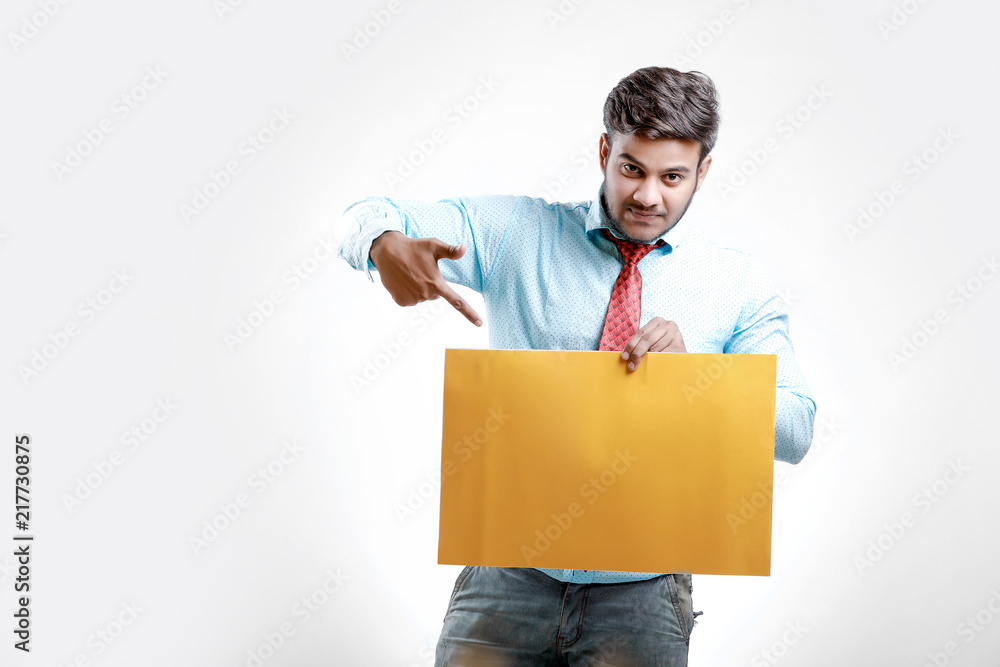 happy Young indian man showing blank poster happy Young indian man showing blank poster