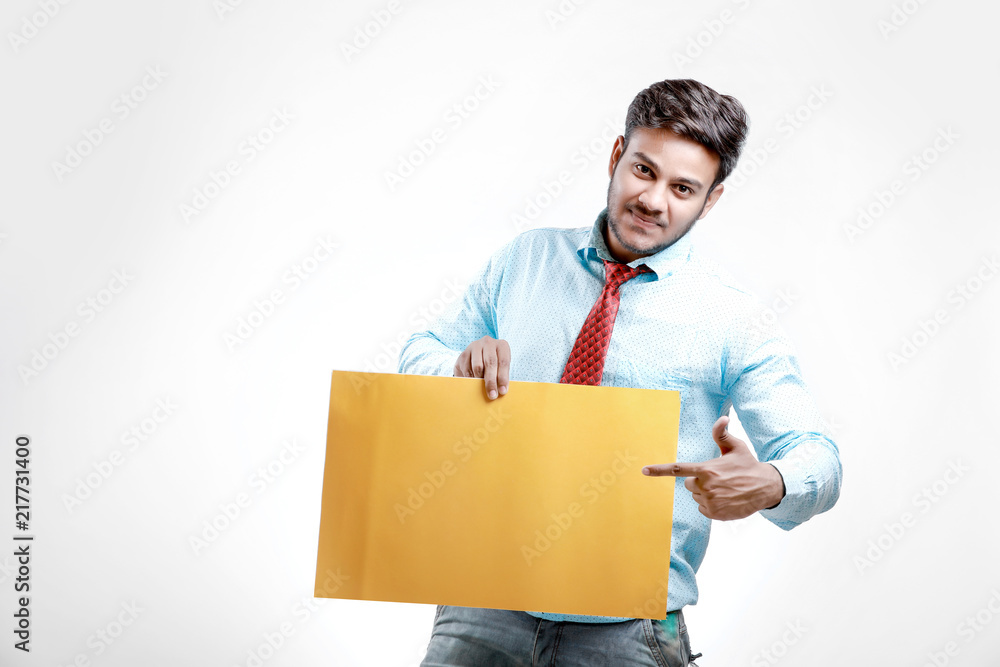 happy Young indian man showing blank poster happy Young indian man showing blank poster