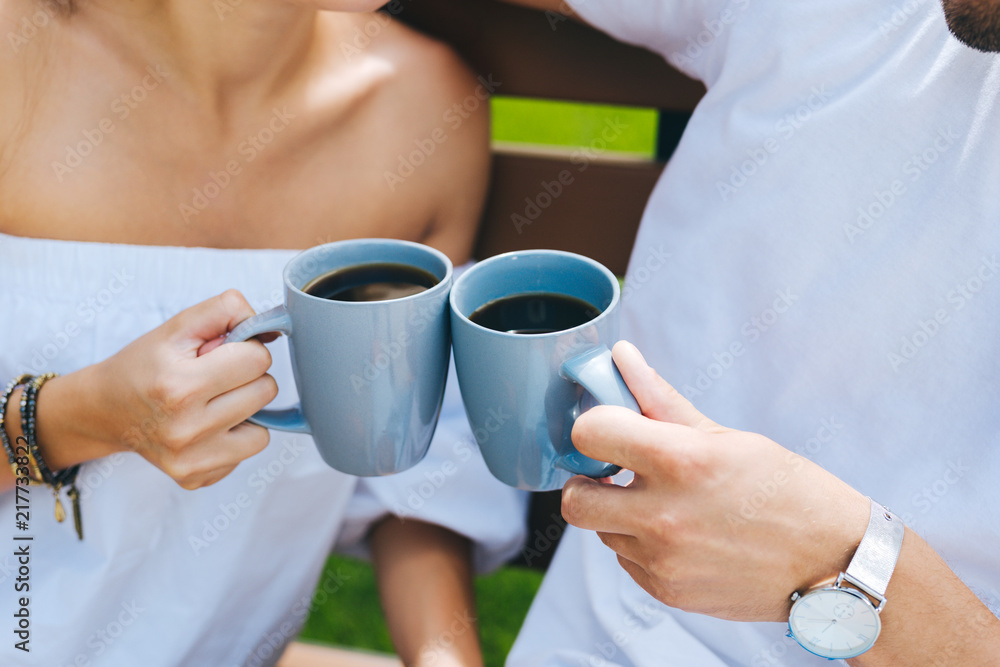 Energizing drink. Close up of cups with coffee being in hands of nice joyful people Energizing drink. Close up of cups with coffee being in hands of nice joyful people