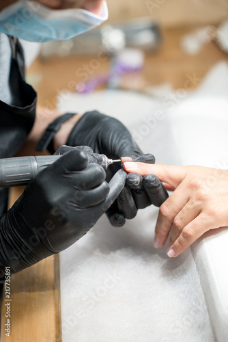 The process of manicure in a beauty salon  close-up.