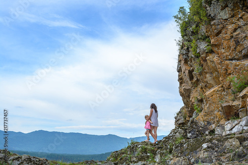 Mom and daughter are traveling in the mountains. summer active tourism © penyushkin