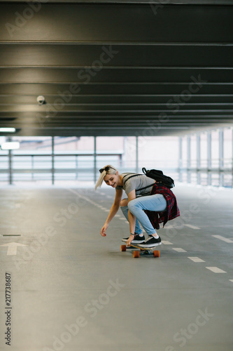 Young hipster woman with skateboard 