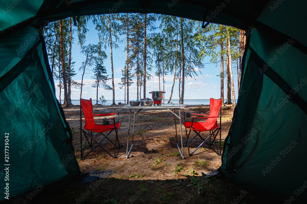 custom made wallpaper toronto digitalCamping in the middle of the forest, taken from inside the tent. View of the folding table and chairs with gas stove in the background of camping in the forest.