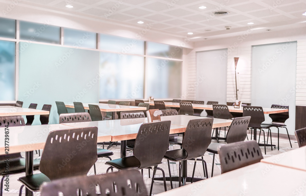 Modern interior of cafeteria or canteen with chairs and tables Modern interior of cafeteria or canteen with chairs and tables