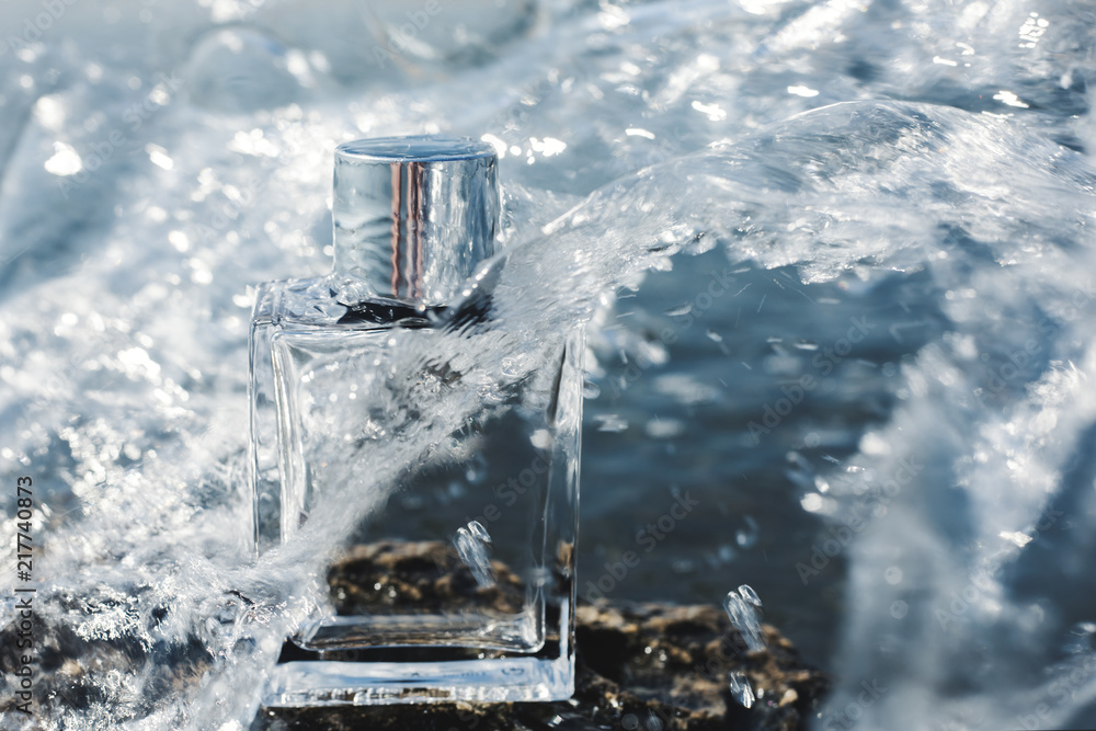 Perfume bottle in water splashes Perfume bottle in water splashes