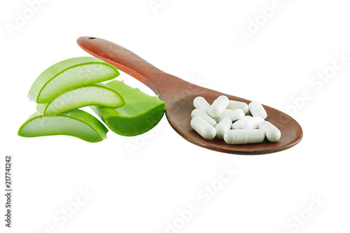 slice alovera with capsules herbal inwooden spoon isolated on white background photo