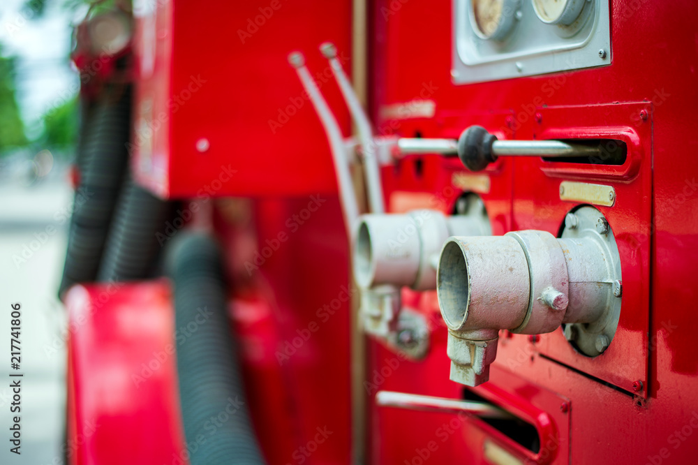 closeup pipe hydrant on a fire truck with soft-focus and over light in the background closeup pipe hydrant on a fire truck with soft-focus and over light in the background