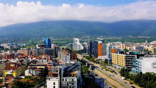 Wallpaper Mural Hyperlapse/timelapse of a view to a mountain covered with moving clouds and beneath are buildings with car traffic on a wide road. Torontodigital.ca