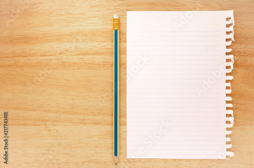Notebook Lined Paper and pencil on wood Background