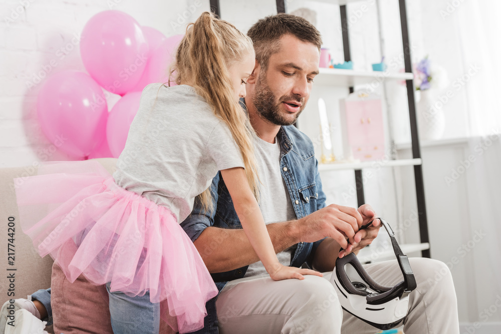handsome father and cute daughter using vr headset together at home handsome father and cute daughter using vr headset together at home