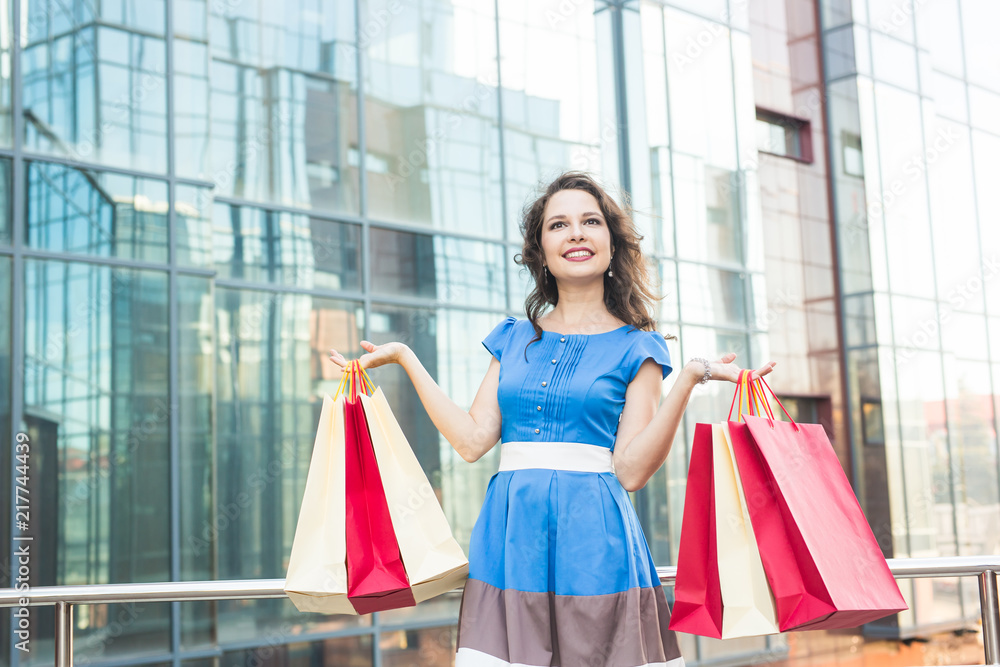 happiness, consumerism, sale and people concept - woman with shopping bags happiness, consumerism, sale and people concept - woman with shopping bags