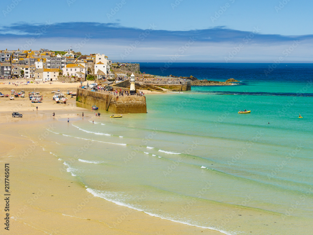 The golden sands and clear blue-green sea of St Ives, in Cornwall, England.
